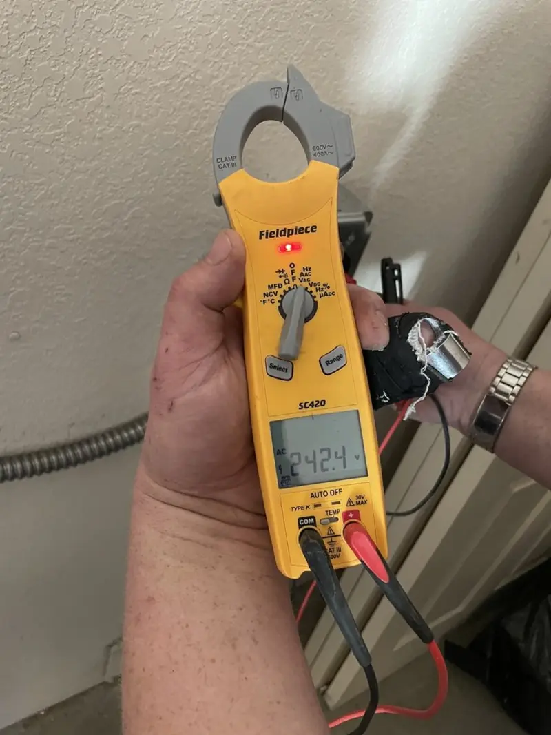 Voltage testing with clamp meter during Recessed Lighting Installation in Globe